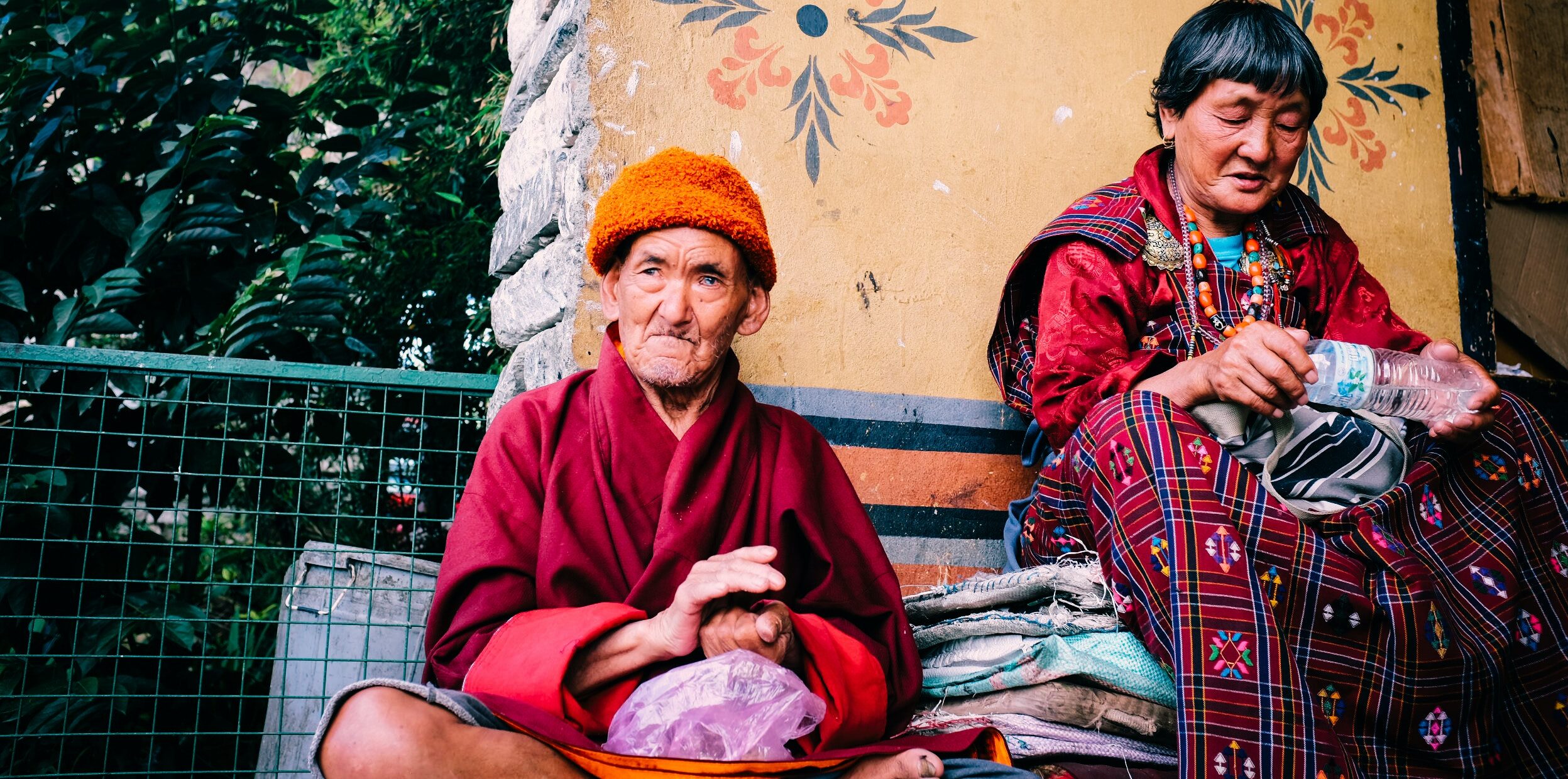 Bhutanese man and woman chanting while sitting.