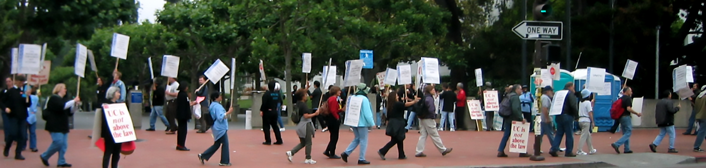 People on the street with placards as part of a 2008 University of California labor strike by the University Professional and Technical Employees, CWA Local 9119.