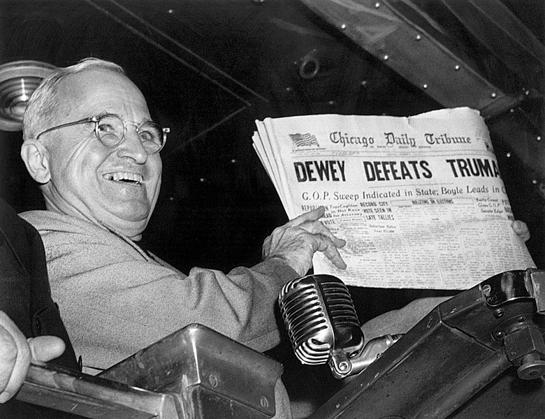 Harry S. Truman holding the Chicago Daily Tribune with the erroneous headline, “Dewey Defeats Truman.”