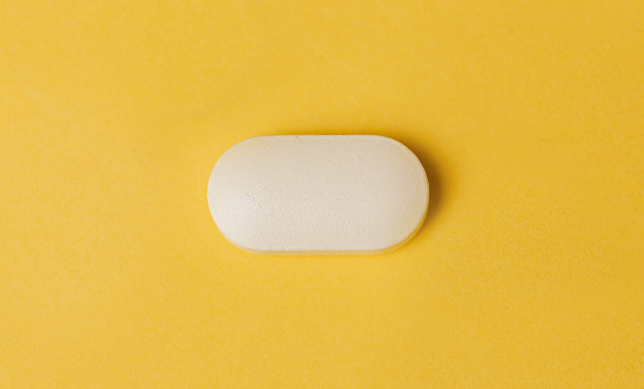 A large off-white pill against an orange background.