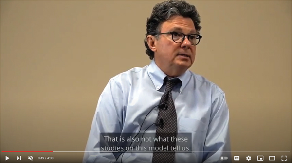 A still image from a video features Doctor Ross Greene seated against a plain beige background. He appears to be mid-explanation, stating that the findings discussed are not consistent with what studies on the model have shown. Captions at the bottom partially display his statement.