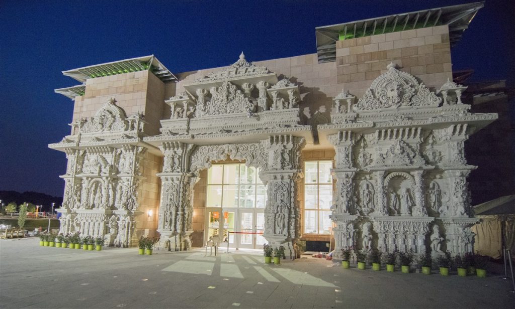 Exterior photo of the BAPS Shri Swaminarayan Mandir in Robbinsville, New Jersey at night