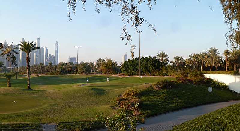 A view of the green grass and trees at Emirates Golf Club in Dubai