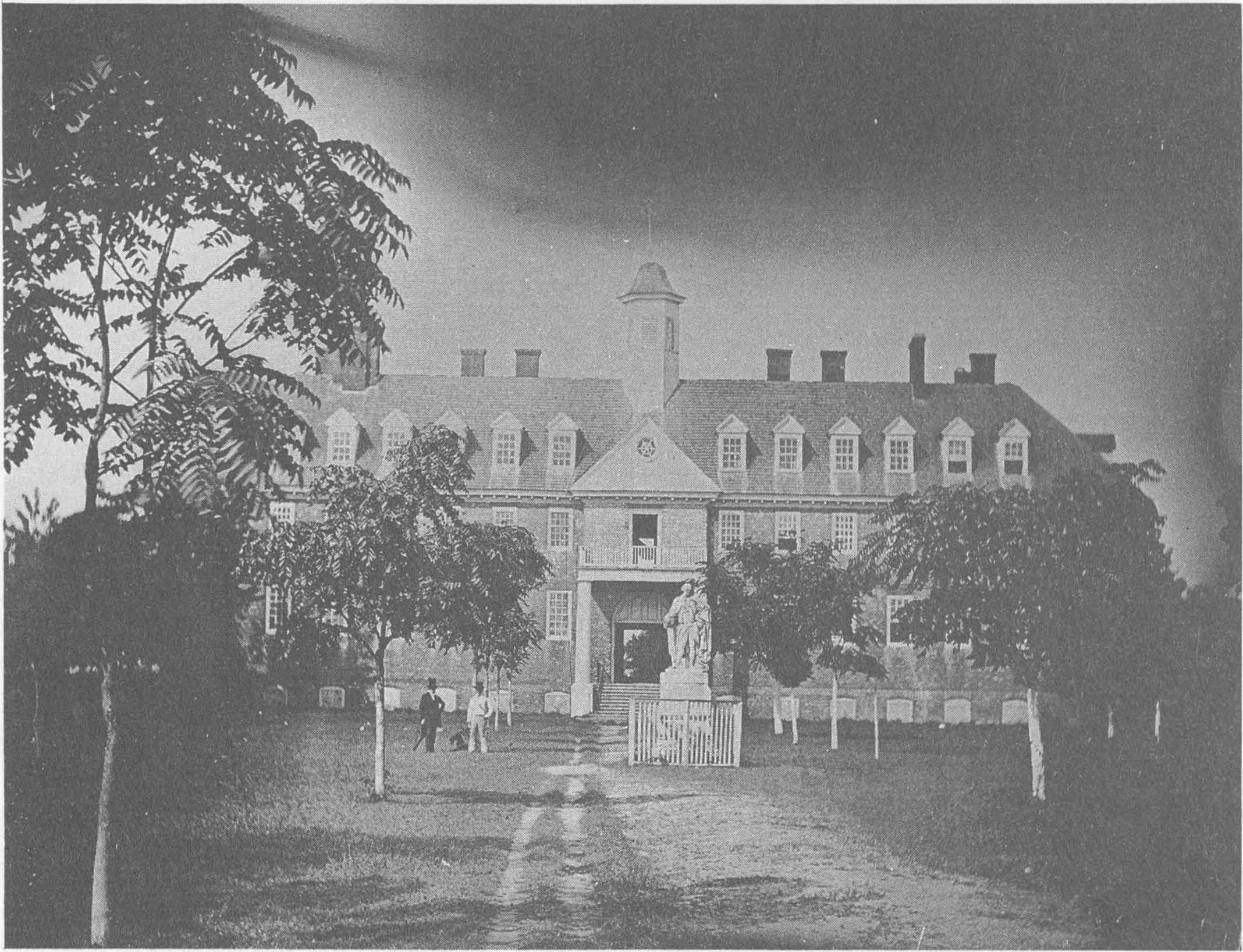 Front of the main building, with Lord Botetourt statue. Several small trees are in the yard.