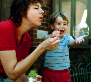 photo of mother and child blowing bubbles