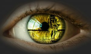 photo of yellow eye with reflection of sad young women