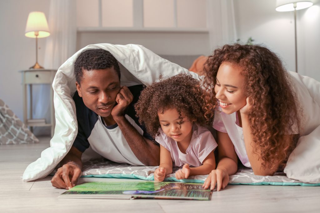 Parents read with their child.