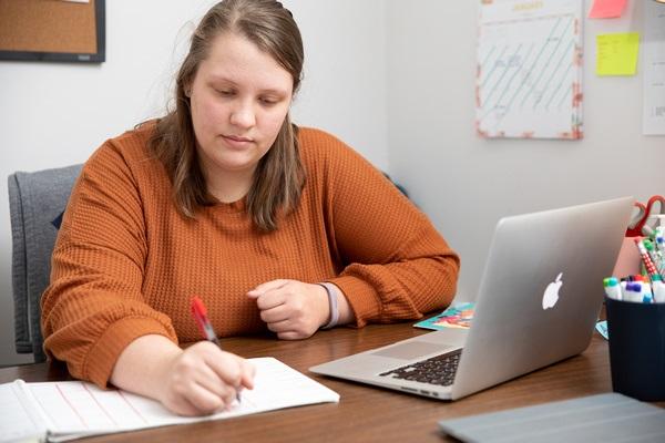 An early childhood educator is working at her desk.