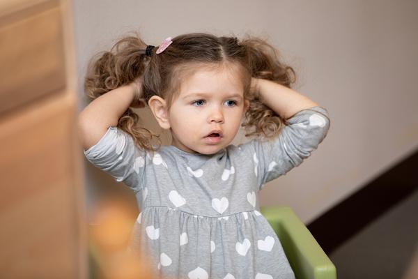 A child sits in a chair listening.