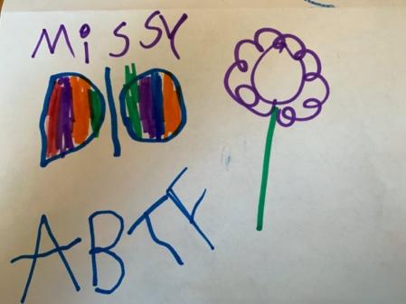 Child's writing has the name Missy in the top left corner. There is a picture oof a colorful butterfly under "Missy" and a flower next to the butterfly. "ABTF" is written under the butterfly in capital letters.