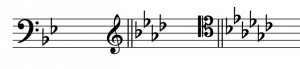 A two-flat key signature after a bass clef, a four-flat key signature after a treble clef, and a six-flat key signature after a tenor clef.