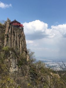 Temple on a cliff overlooking a city